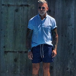 Wear a white and blue vertical striped short sleeve shirt with navy polka dot shorts to put together a daily outfit that's full of style and personality.