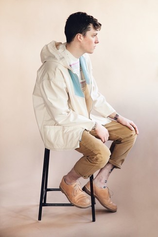 Tan Leather Derby Shoes Outfits: A white and blue windbreaker and khaki jeans are a nice combination worth having in your day-to-day off-duty wardrobe. For something more on the sophisticated side to complete this ensemble, add tan leather derby shoes to this outfit.