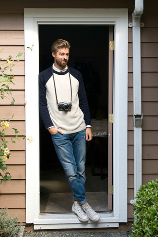 White and Navy Crew-neck Sweater Outfits For Men: A white and navy crew-neck sweater and blue ripped jeans are a smart combination to have in your current casual wardrobe. White canvas high top sneakers are a savvy pick to complement your look.