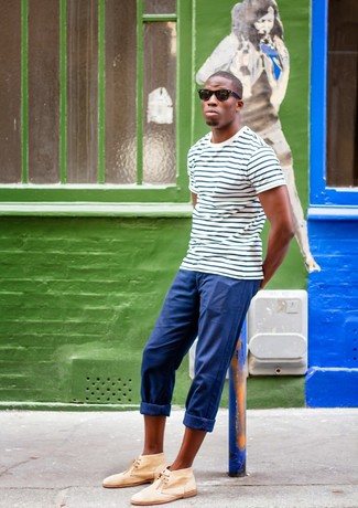 A big yes to this relaxed combination of a white and navy horizontal striped crew-neck t-shirt and blue chinos! Avoid looking too casual by rounding off with tan suede desert boots.
