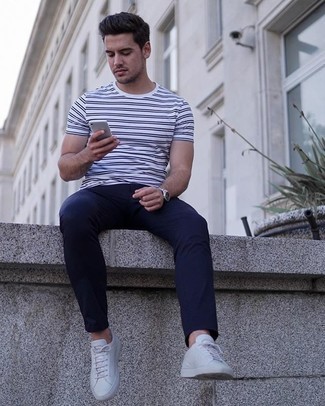 White Horizontal Striped Crew-neck T-shirt Outfits For Men: If you prefer a more laid-back approach to dressing up, why not consider wearing a white horizontal striped crew-neck t-shirt and navy chinos? White canvas low top sneakers integrate really well within a multitude of looks.