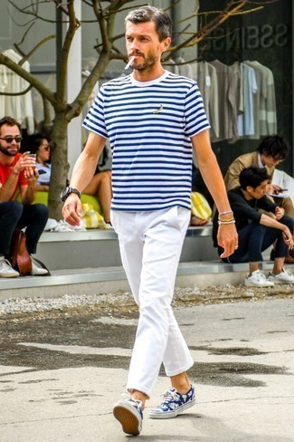 Blue Canvas Low Top Sneakers Outfits For Men: Make a white and navy horizontal striped crew-neck t-shirt and white chinos your outfit choice and you'll be ready for wherever this day takes you. When it comes to footwear, this ensemble pairs nicely with blue canvas low top sneakers.