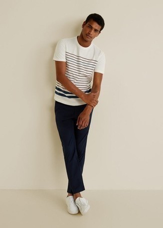 White and Black Horizontal Striped Crew-neck T-shirt Hot Weather Outfits For Men: This pairing of a white and black horizontal striped crew-neck t-shirt and navy chinos will allow you to showcase your expertise in menswear styling even on off-duty days. If you're clueless about how to finish off, add a pair of white canvas low top sneakers to the equation.