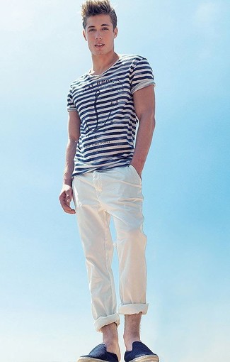 Navy Canvas Espadrilles Outfits For Men: To assemble an off-duty look with a modern twist, rock a white and navy horizontal striped crew-neck t-shirt with white chinos. Feeling venturesome today? Dress up your outfit by finishing with a pair of navy canvas espadrilles.