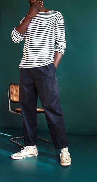 White and Black Horizontal Striped Long Sleeve T-Shirt Summer Outfits For Men: This pairing of a white and black horizontal striped long sleeve t-shirt and navy chinos resonates versatility and effortless menswear style. Our favorite of a ton of ways to round off this ensemble is with a pair of white canvas high top sneakers. When summer settles in you're looking for an ensemble to keep you fresh and on-trend –– this look is just the one you need.