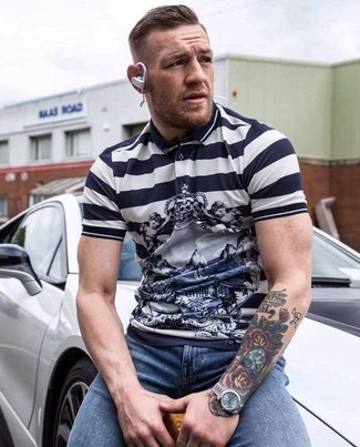 Conor McGregor wearing White and Navy Horizontal Striped Polo, Blue Skinny Jeans, Gold Watch