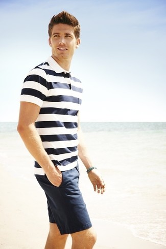 White and Navy Horizontal Striped Polo Outfits For Men: This laid-back pairing of a white and navy horizontal striped polo and navy shorts will draw attention wherever you go.