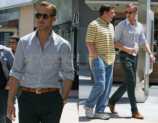 Ryan Gosling wearing White and Navy Vertical Striped Long Sleeve Shirt, Dark Green Dress Pants, Tan Leather Derby Shoes, Brown Leather Belt