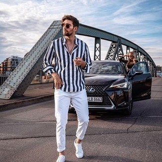 Men's White and Navy Vertical Striped Long Sleeve Shirt, White Jeans, White Canvas Low Top Sneakers, Dark Brown Sunglasses