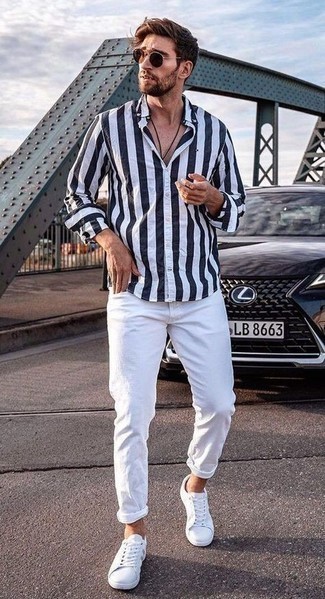 White and Navy Long Sleeve Shirt Outfits For Men: Why not reach for a white and navy long sleeve shirt and white jeans? These items are totally functional and look great worn together. A pair of white canvas low top sneakers is a savvy idea to complete your look.