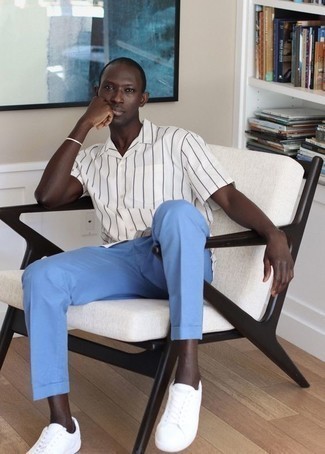 Light Blue Chinos Outfits: If you're scouting for a relaxed yet on-trend ensemble, choose a white and navy vertical striped short sleeve shirt and light blue chinos. Add white canvas low top sneakers to the equation and off you go looking awesome.