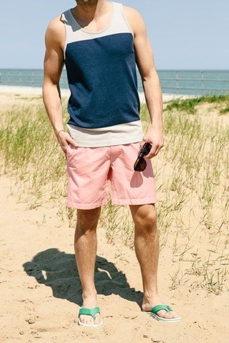 Flip Flops Outfits For Men: A white and navy tank and pink shorts are the perfect base for a multitude of stylish outfits. Go ahead and add flip flops to the equation for a sense of stylish casualness.