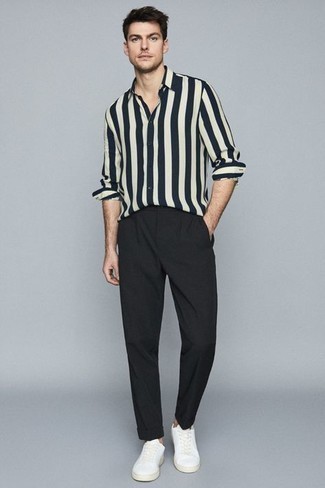 Black Chinos Summer Outfits: Try teaming a white and navy vertical striped long sleeve shirt with black chinos if you seek to look cool and casual without much effort. When it comes to shoes, this getup pairs perfectly with white canvas low top sneakers. This getup is our idea of perfection for blazing hot afternoons.