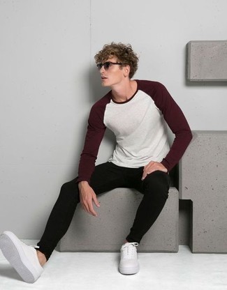 Black Skinny Jeans Outfits For Men: The styling capabilities of a white and red long sleeve t-shirt and black skinny jeans ensure they'll always be on high rotation in your menswear collection. Kick up your outfit with white canvas low top sneakers.