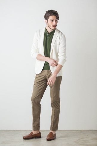 Dark Green Polo Outfits For Men: This combination of a dark green polo and brown chinos makes for the ultimate casual style for today's gent. Complement this outfit with a pair of brown leather loafers to instantly jazz up the outfit.
