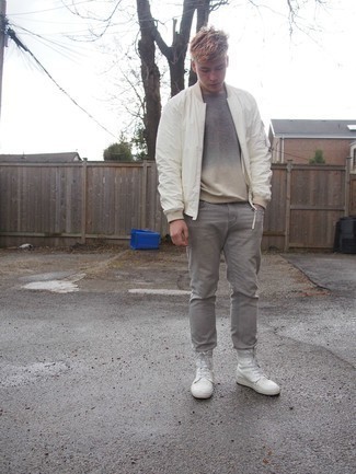 White Leather Casual Boots Outfits For Men: Go for a straightforward but at the same time neat and relaxed option by combining a white bomber jacket and grey jeans. Throw white leather casual boots into the mix for an element of polish.