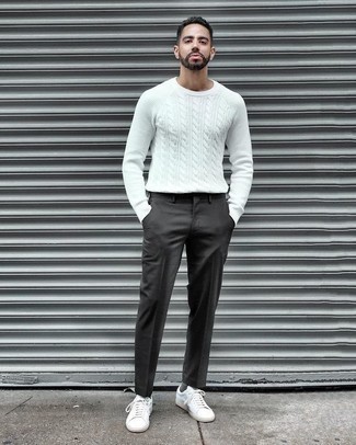 White Cable Sweater Outfits For Men: Indisputable proof that a white cable sweater and charcoal dress pants look awesome when matched together in an elegant look for today's guy. Dress down your outfit by finishing off with white canvas low top sneakers.