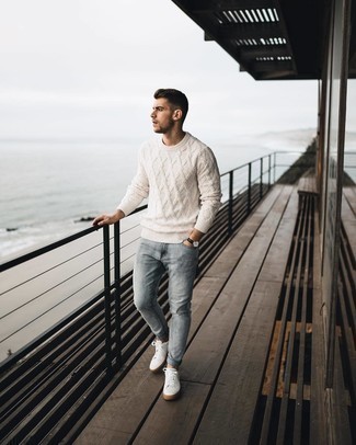 White Cable Sweater Outfits For Men: Marrying a white cable sweater with light blue jeans is a great pick for a casually stylish look. Let your outfit coordination skills truly shine by finishing off your look with white canvas low top sneakers.