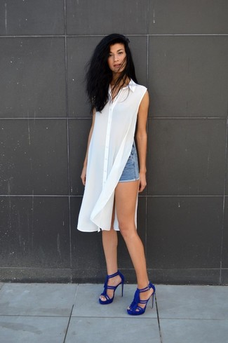 White Shirtdress Outfits: This seriously chic getup is really pared down: a white shirtdress and blue denim shorts. Wondering how to finish off? Complete your ensemble with blue suede heeled sandals to amp up the glam factor.