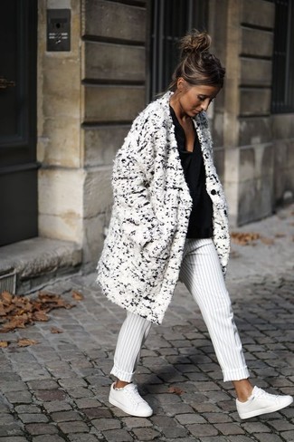 White Leather Low Top Sneakers Outfits For Women: This combination of a white boucle coat and white and black vertical striped dress pants might pack a punch, but it's also extremely easy to replicate. Let your outfit coordination credentials truly shine by finishing this getup with a pair of white leather low top sneakers.