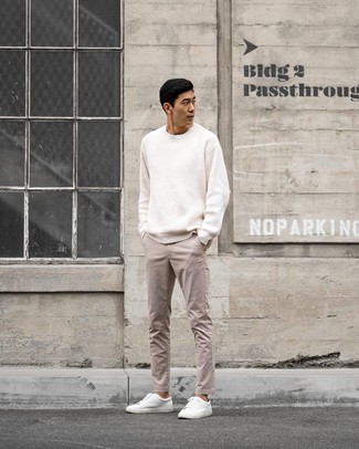 Beige Chinos Outfits: For something on the casual and cool end, you can wear a white crew-neck sweater and beige chinos. Put a modern spin on your outfit by finishing off with a pair of white canvas low top sneakers.