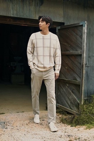White Crew-neck Sweater Casual Outfits For Men: This pairing of a white crew-neck sweater and grey chinos is a safe go-to for an incredibly stylish look. Puzzled as to how to finish? Throw white canvas low top sneakers into the mix for a more casual vibe.