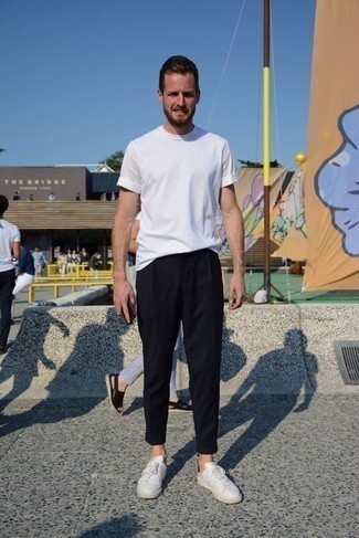 White and Black Sneakers Outfits For Men: For a look that's extremely easy but can be styled in a myriad of different ways, go for a white crew-neck t-shirt and black chinos. Throw white and black sneakers into the mix to easily rev up the street cred of this outfit.