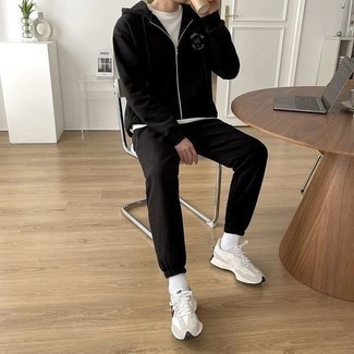 White Athletic Shoes Outfits For Men: This casual street style pairing of a white crew-neck t-shirt and a black track suit couldn't possibly come across as anything other than seriously stylish. When it comes to footwear, this ensemble is complemented really well with white athletic shoes.