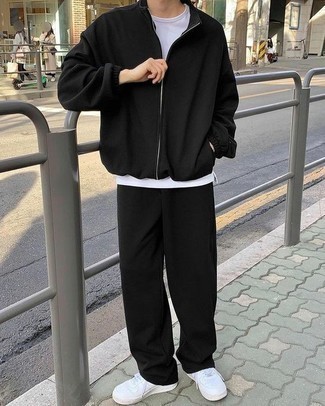 Black Track Suit Outfits For Men: If you gravitate towards modern casual combinations, why not marry a black track suit with a white crew-neck t-shirt? Add white leather low top sneakers to avoid looking too casual.
