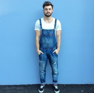 Black Plimsolls Outfits For Men: Want to inject your wardrobe with some casual urban style? Choose a white crew-neck t-shirt and blue denim overalls. And it's amazing what a pair of black plimsolls can do for the look.