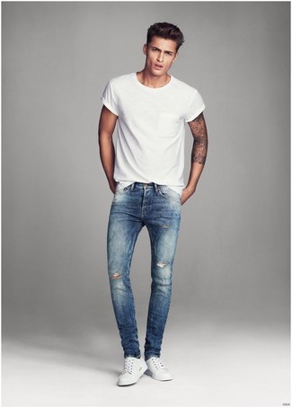 Navy Ripped Skinny Jeans Outfits For Men: For something more on the cool and casual end, you can easily dress in a white crew-neck t-shirt and navy ripped skinny jeans. A good pair of white low top sneakers is the most effective way to punch up this outfit.