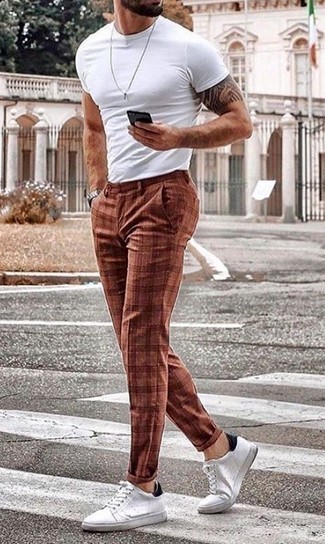 Brown Plaid Chinos Outfits: Rock a white crew-neck t-shirt with brown plaid chinos to feel fully confident and look casually dapper. Introduce a pair of white and black leather low top sneakers to your outfit to pull the whole look together.
