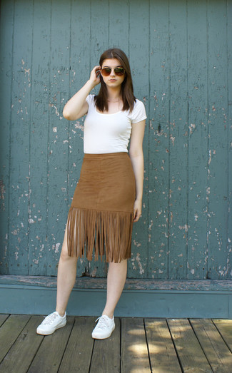 Brown Fringe Suede Pencil Skirt Outfits: Combining a white crew-neck t-shirt with a brown fringe suede pencil skirt is an on-point choice for an edgy and casual look. Go ahead and add white low top sneakers to the equation for a dose of stylish nonchalance.
