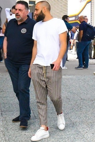 Dark Brown Vertical Striped Chinos Outfits: Want to infuse your closet with some fashion-forward dapperness? Rock a white crew-neck t-shirt with dark brown vertical striped chinos. Introduce a pair of white and red leather low top sneakers to the mix and the whole getup will come together.