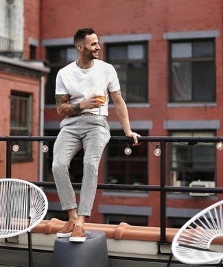 Slip-on Sneakers Outfits For Men: Why not marry a white crew-neck t-shirt with grey chinos? Both of these pieces are super practical and will look cool matched together. Complement this outfit with slip-on sneakers and you're all set looking awesome.
