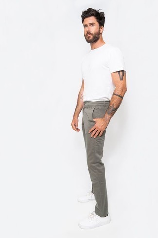 Grey Chinos with White Crew-neck T-shirt Summer Outfits After 40: This off-duty combo of a white crew-neck t-shirt and grey chinos is a tested option when you need to look casually stylish but have zero time. Our favorite of an infinite number of ways to round off this outfit is white canvas low top sneakers. Totally appropriate for roasting hot afternoons, you can wear a variation of this ensemble all season long. Those who are curious whether you can still rock cool casual style after forty, you have your answer.