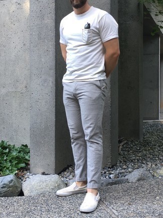 White Canvas Slip-on Sneakers Outfits For Men: This off-duty combo of a white crew-neck t-shirt and grey chinos will draw attention wherever you go. Enter white canvas slip-on sneakers into the equation for extra style points.