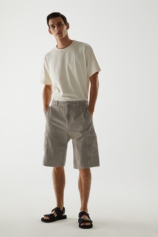 Black Canvas Sandals Outfits For Men: Fashionable and comfortable, this casual combo of a white crew-neck t-shirt and grey denim shorts brings excellent styling opportunities. And if you wish to immediately dress down this look with a pair of shoes, add black canvas sandals to the equation.