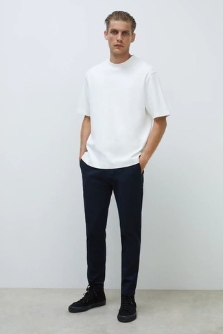 Black Canvas High Top Sneakers Outfits For Men: Opt for a white crew-neck t-shirt and navy chinos to achieve an extra stylish and modern-looking relaxed casual outfit. For something more on the casually cool end to complete this look, complete your look with a pair of black canvas high top sneakers.