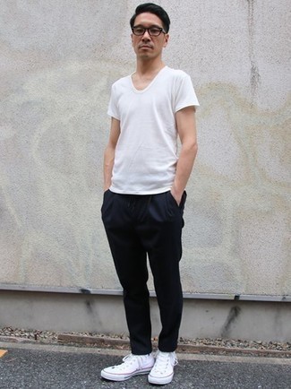 White Canvas High Top Sneakers Hot Weather Outfits For Men: This look with a white crew-neck t-shirt and navy chinos isn't so hard to pull off and is easy to adapt. Complement your look with a pair of white canvas high top sneakers to easily amp up the cool of your look.