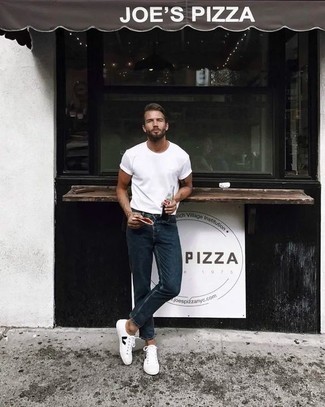 White and Black Low Top Sneakers Hot Weather Outfits For Men: A white crew-neck t-shirt and navy jeans are essential in any modern man's functional casual closet. A pair of white and black low top sneakers can integrate nicely within plenty of combos.