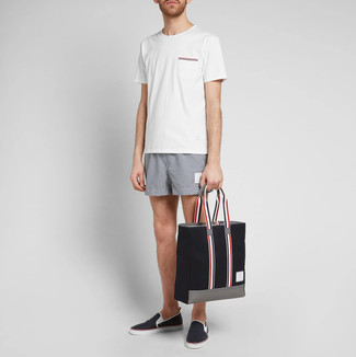 Black Canvas Tote Bag Outfits For Men: Master casual city menswear in a white crew-neck t-shirt and a black canvas tote bag. Black leather slip-on sneakers will immediately lift up even the most basic of ensembles.