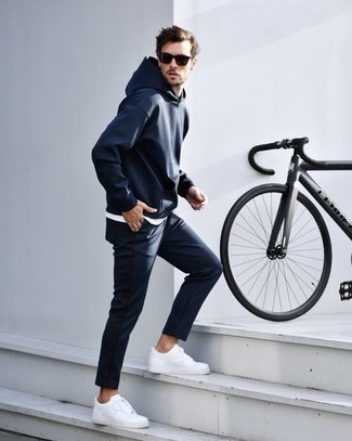 Navy Track Suit Outfits For Men: A navy track suit and a white crew-neck t-shirt are a nice combo to incorporate into your daily casual wardrobe. For something more on the classier end to complement your look, add white leather low top sneakers to the mix.