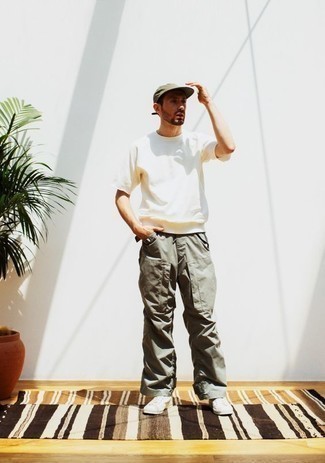 Olive Cargo Pants Hot Weather Outfits: If you're searching for a relaxed casual but also on-trend getup, pair a white crew-neck t-shirt with olive cargo pants. Look at how well this ensemble goes with a pair of white canvas low top sneakers.