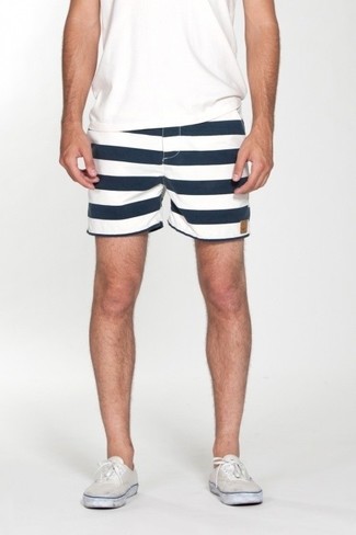 White and Navy Shorts Outfits For Men: If you gravitate towards comfort dressing, why not wear this pairing of a white crew-neck t-shirt and white and navy shorts? The whole look comes together perfectly if you complete your look with white canvas low top sneakers.