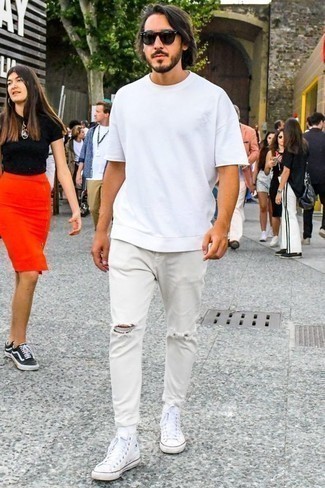 White Ripped Jeans Outfits For Men: A white crew-neck t-shirt and white ripped jeans are essential in any modern gent's functional casual arsenal. All you need is a pair of white canvas high top sneakers to complete your look.