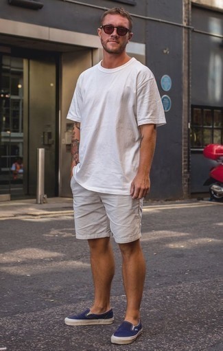 Navy Canvas Slip-on Sneakers Outfits For Men: A white crew-neck t-shirt and white shorts paired together are a smart match. Wondering how to complement this look? Rock navy canvas slip-on sneakers to kick up the wow factor.