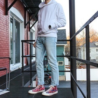 Multi colored High Top Sneakers Outfits For Men: This casual and cool ensemble is really pared down: a white hoodie and light blue jeans. If you want to immediately tone down this getup with one single piece, why not introduce multi colored high top sneakers to the mix?