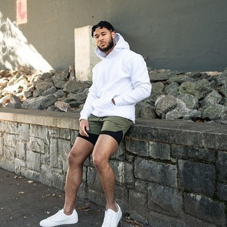 Dark Green Sports Shorts Outfits For Men: Extremely dapper, this combo of a white hoodie and dark green sports shorts provides with variety. Introduce white canvas low top sneakers to the mix to completely shake up the ensemble.