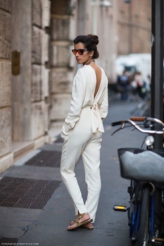 White Jumpsuit Outfits: If it's ease and functionality that you appreciate in a look, wear a white jumpsuit. Rev up this whole getup by sporting a pair of gold leather flat sandals.
